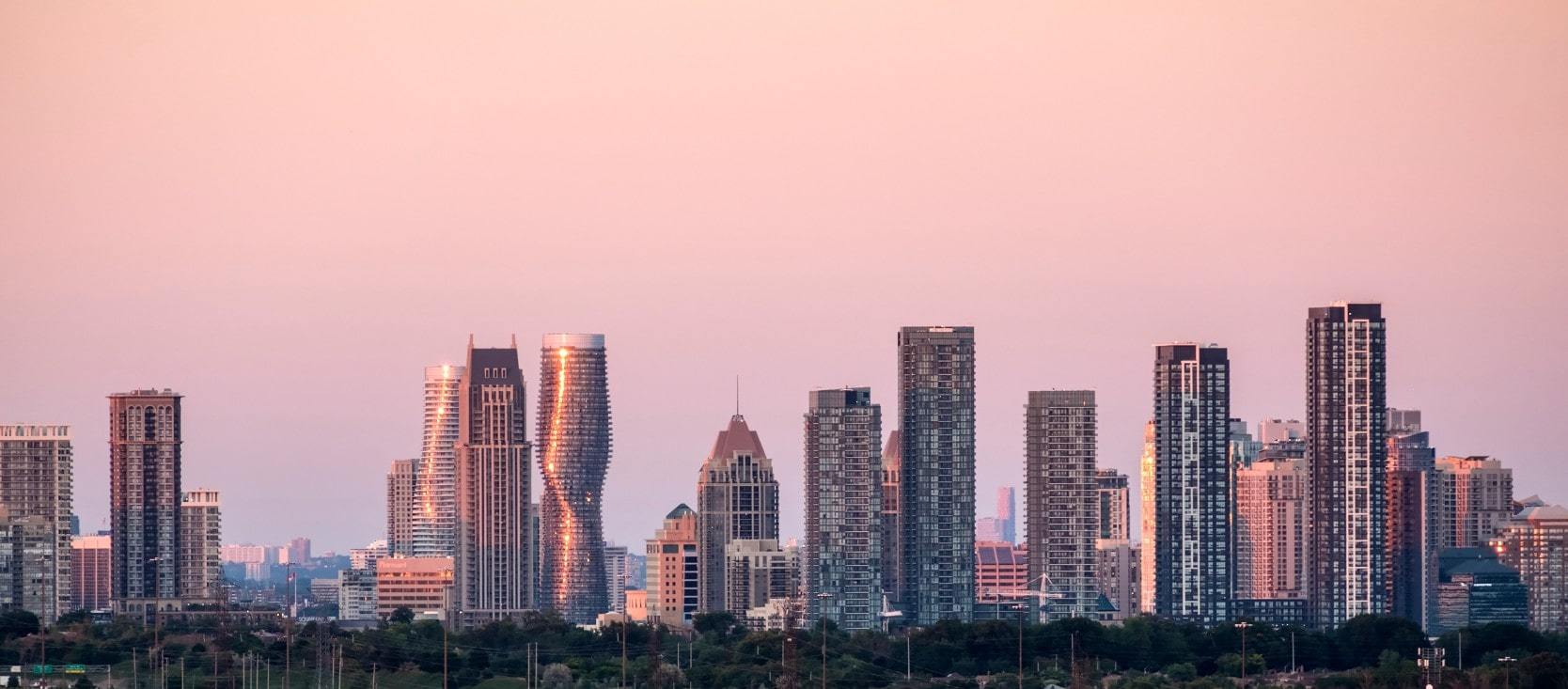 Mississauga skyline with high-rise condos and office buildings at sunset